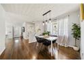 Bright dining area featuring hardwood floors, modern lighting, and natural light from a large window at 1755 Fairburn Sw Rd, Atlanta, GA 30331