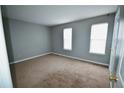 Neutral bedroom offers natural light and plush carpet flooring at 755 Heritage Valley Rd, Norcross, GA 30093