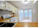 Eat-in kitchen with white appliances, wood countertops, and bay window at 755 Heritage Valley Rd, Norcross, GA 30093