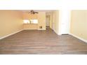 Open-concept living area with laminate wood flooring, leading into the kitchen area at 775 Heritage Valley Rd, Norcross, GA 30093