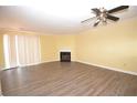 Spacious living room featuring laminate wood flooring, neutral walls, and a cozy fireplace at 775 Heritage Valley Rd, Norcross, GA 30093