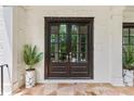 Elegant double front door framed by white brick and potted plants at 980 Fenimore Cir, Atlanta, GA 30350