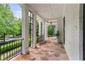 Spacious porch with stone floor and white pillars, perfect for outdoor living at 980 Fenimore Cir, Atlanta, GA 30350