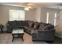 Comfortable living room features a large sectional sofa, ceiling fan, and natural light at 985 Romer Pl, Stone Mountain, GA 30083