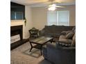 Cozy living room boasts a fireplace and large window and a comfortable sectional sofa at 985 Romer Pl, Stone Mountain, GA 30083