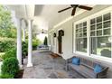 Inviting front porch with stone floor, white columns, and ample seating at 2909 Redding Road Northeast, Atlanta, GA 30319