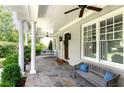 Inviting covered front porch features stone flooring, columns, and a swing at 2909 Redding Road Northeast, Atlanta, GA 30319