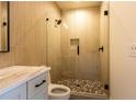 Modern bathroom featuring a glass shower, beautiful tile work, stylish fixtures, and a pebble tile shower floor at 344 Michael Dr, Alpharetta, GA 30009