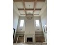 A spacious living room with wood beams, built-in cabinets, fireplace, and large windows providing natural light at 344 Michael Dr, Alpharetta, GA 30009