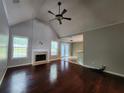 Open living room with beautiful hardwood floors, fireplace and large windows at 5619 Wandering Vine Se Ln, Mableton, GA 30126