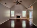 Bright living room featuring a fireplace, high ceilings and dark hardwood floors at 5619 Wandering Vine Se Ln, Mableton, GA 30126