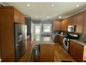 Spacious kitchen features granite countertops, stainless steel appliances, and hardwood flooring at 1517 Gilstrap Nw Ln, Atlanta, GA 30318
