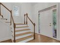 Bright entryway featuring hardwood floors, stairway, and a stylish door with decorative glass at 2010 Riverside Rd, Roswell, GA 30076