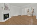 Spacious living room with hardwood floors, fireplace, and ample natural light at 2010 Riverside Rd, Roswell, GA 30076