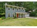 Traditional two-story home with a covered front porch, a well-maintained lawn, and a two-car garage at 4772 Ridgewood Nw Ct, Acworth, GA 30102