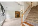Spacious living room with a stone fireplace and staircase; the perfect place to relax and entertain guests at 4772 Ridgewood Nw Ct, Acworth, GA 30102
