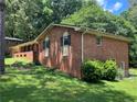Brick home featuring well maintained landscaping with black shuttered windows offering classic charm at 5607 Mountainbrooke Ct, Stone Mountain, GA 30087