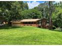 Inviting single-level brick home with attached garage, and a well-manicured lawn at 5607 Mountainbrooke Ct, Stone Mountain, GA 30087