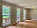 Bright living room boasting large windows, hardwood floors, and neutral wall colors at 5607 Mountainbrooke Ct, Stone Mountain, GA 30087