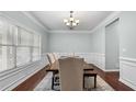 Elegant dining room with hardwood floors, detailed trim, chandelier, and large window at 572 Boulder View Pkwy, Dallas, GA 30157