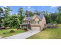Inviting two-story home with well-maintained lawn, stone accents, and a refreshing above-ground pool at 572 Boulder View Pkwy, Dallas, GA 30157