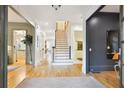 Bright foyer with hardwood floors, staircase, and elegant architectural details at 2112 Murren Se Dr, Smyrna, GA 30080