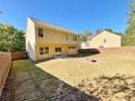 Spacious backyard featuring a well-maintained lawn, wooden fence, and patio area, perfect for outdoor activities and relaxation at 125 Redsage Rdg, Atlanta, GA 30349