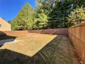 Large, fenced backyard showcasing a well-kept lawn, ideal for outdoor gatherings and providing privacy at 125 Redsage Rdg, Atlanta, GA 30349