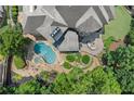 Overhead view of a gorgeous pool, spa, and patio area, complemented by lush landscaping and an outdoor fire pit at 4105 Cougar Ne Pt, Marietta, GA 30066