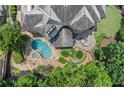 Overhead view of a gorgeous pool, spa, and patio area, complemented by lush landscaping and an outdoor fire pit at 4105 Cougar Ne Pt, Marietta, GA 30066