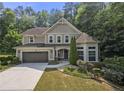 Traditional two-story home with a two-car garage and manicured landscaping at 2740 Creekside Manor Dr, Powder Springs, GA 30127