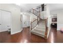Inviting foyer with hardwood floors, staircase, and neutral wall paint at 2740 Creekside Manor Dr, Powder Springs, GA 30127