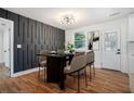 Chic dining room with a modern table set, decorative wall, and hardwood flooring at 904 Fairburn Nw Pl, Atlanta, GA 30331