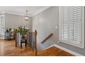 Elegant entryway features hardwood floors, a staircase with iron spindles, and a window with plantation shutters at 1251 Brickton Nw Dr, Atlanta, GA 30318