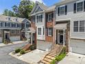 Stylish townhomes with brick and siding exteriors, enhanced by well-maintained landscaping and inviting curb appeal at 1251 Brickton Nw Dr, Atlanta, GA 30318