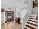Elegant foyer with hardwood floors, high ceiling, staircase, and a decorative glass front door at 3535 Fairgreen Ct, Douglasville, GA 30135