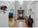 Elegant foyer with hardwood floors, a high ceiling, an ornate cuckoo clock, and a decorative stained glass front door at 3535 Fairgreen Ct, Douglasville, GA 30135