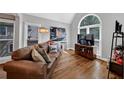 Cozy living room with hardwood floors, large windows, and a comfortable leather sofa at 3535 Fairgreen Ct, Douglasville, GA 30135