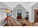 Bright living room features hardwood floors, a comfortable sofa, and a large arched window at 3535 Fairgreen Ct, Douglasville, GA 30135