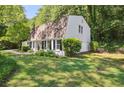 Exterior view of a single-Gathering home with manicured lawn, mature shade trees, and white siding at 4234 Long Branch Ct, Brookhaven, GA 30319