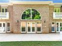Beautiful home exterior featuring brick facade, large windows, and a spacious patio for outdoor living at 8370 Royal Melbourne Way, Duluth, GA 30097
