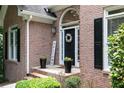 Close-up of a brick home's front door with a decorative wreath and a welcome sign at 1418 Winborn Nw Cir, Kennesaw, GA 30152