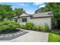 Exterior view of home showing concrete driveway, white siding, brown trim and manicured landscaping at 2296 N Shallowford Rd, Atlanta, GA 30341