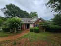 Inviting single-story home with manicured landscaping, a walkway, and a brick facade at 3502 Tiffany Se Dr, Conyers, GA 30013