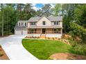 Charming two-story home with a welcoming front porch and a spacious three-car garage at 3702 Running Fox Dr, Marietta, GA 30062