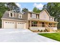 Charming two-story home with a welcoming front porch and a spacious three-car garage at 3702 Running Fox Dr, Marietta, GA 30062