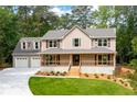 Charming two-story home with a welcoming front porch and a spacious three-car garage at 3702 Running Fox Dr, Marietta, GA 30062