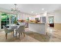 An updated kitchen with stainless appliances, a breakfast area, and a lovely view of the landscaped yard at 11785 Mountain Laurel Dr, Roswell, GA 30075