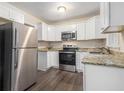 Modern kitchen featuring stainless steel appliances, granite countertops, and white cabinets at 2083 Green Forrest Dr, Decatur, GA 30032