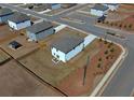 Aerial view of a home with a fenced yard, located in a neighborhood with mature landscaping at 301 Amsterdam Way, Hampton, GA 30228